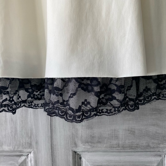 Ivory and black Cocktail dress with lace trim along bottom. - Picture 3 of 5